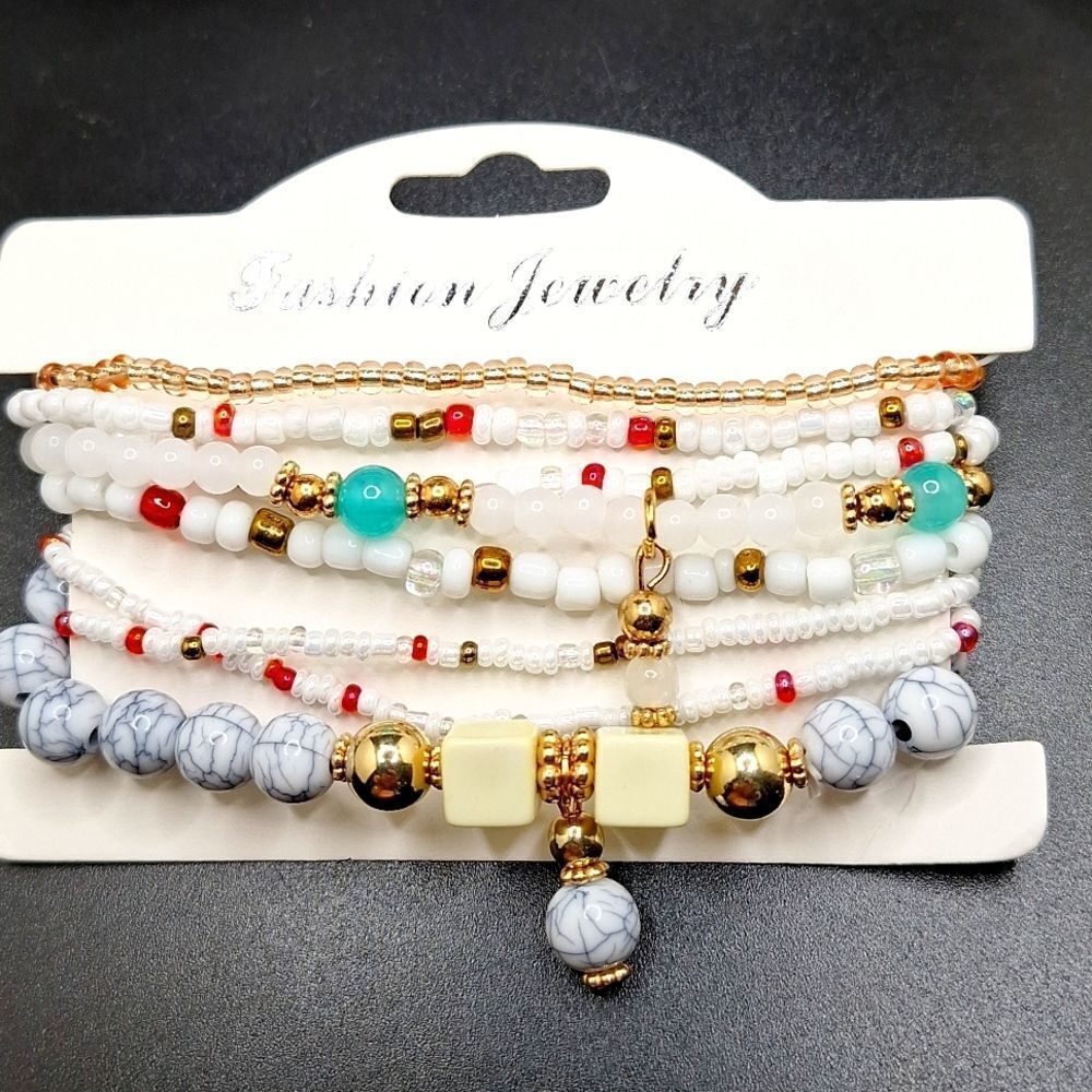 white and gold beaded layered bracelets